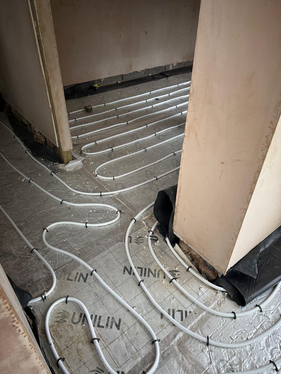 Underfloor heating loops running from room to room