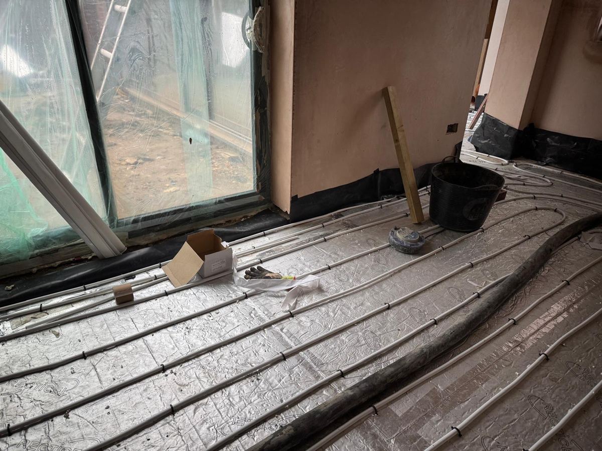 Underfloor heating pipes clipped down on insulated boards